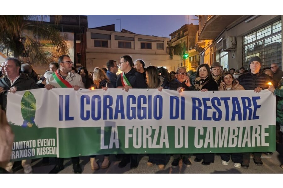 Cittadini in corteo con lo slogan "Il coraggio di restare
